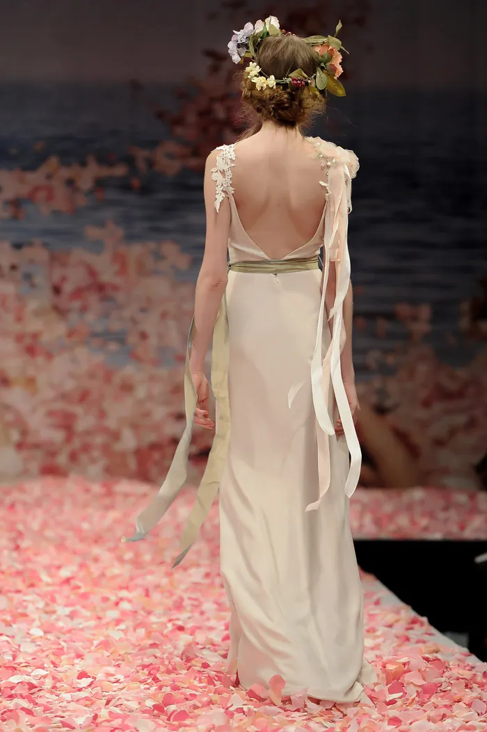 Claire Pettibone 2013 Fall Collection – Maiden. Ivory linen with guipure leaves and jeweled blossom shoulder with green ribbon waist sash. theweddingnotebook.com