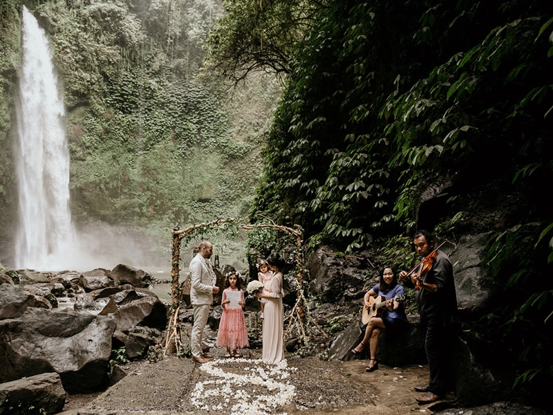Renewing Their Vows In An Intimate Family Affair at Nungnung Waterfall Bali For Their 10th Anniversary